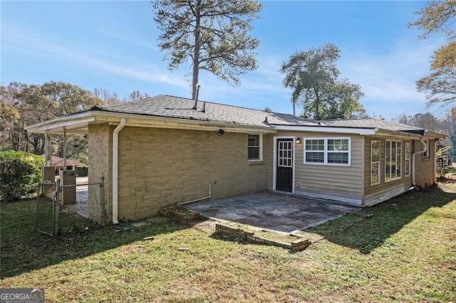 rear view of property with a patio area and a lawn