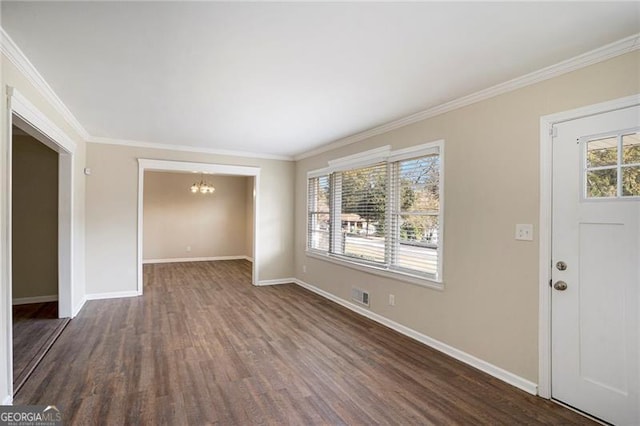 foyer featuring dark hardwood / wood-style flooring, a healthy amount of sunlight, and ornamental molding