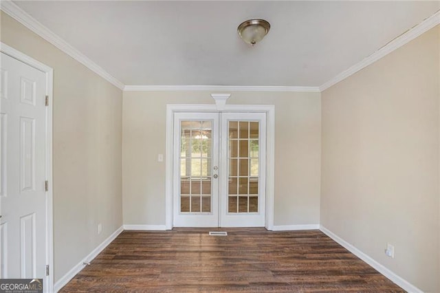 spare room with french doors, ornamental molding, and dark wood-type flooring