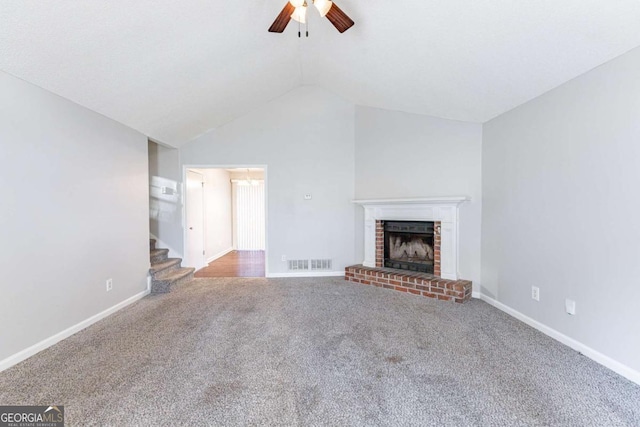 unfurnished living room with carpet flooring, a fireplace, ceiling fan, and lofted ceiling