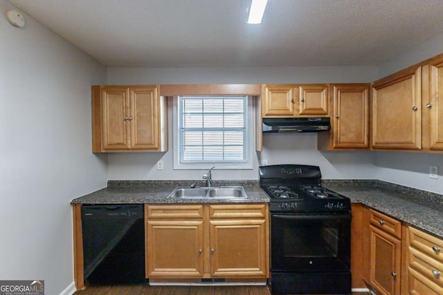 kitchen with dark stone counters, sink, black appliances, and dark hardwood / wood-style floors