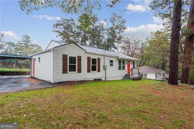 rear view of property featuring a yard