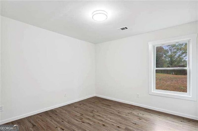 empty room featuring dark wood-type flooring