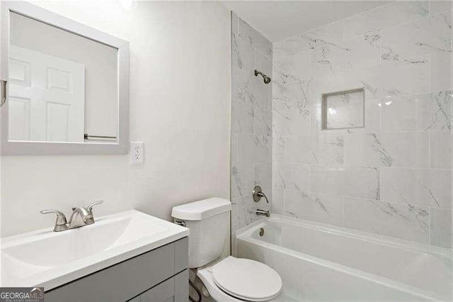 full bathroom with vanity, toilet, and tiled shower / bath combo