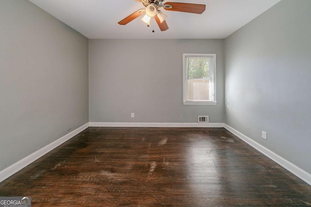 unfurnished room with ceiling fan and dark wood-type flooring