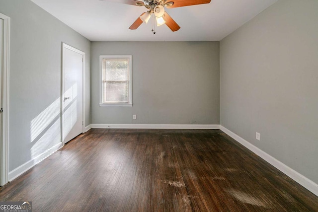 unfurnished room featuring dark hardwood / wood-style floors and ceiling fan