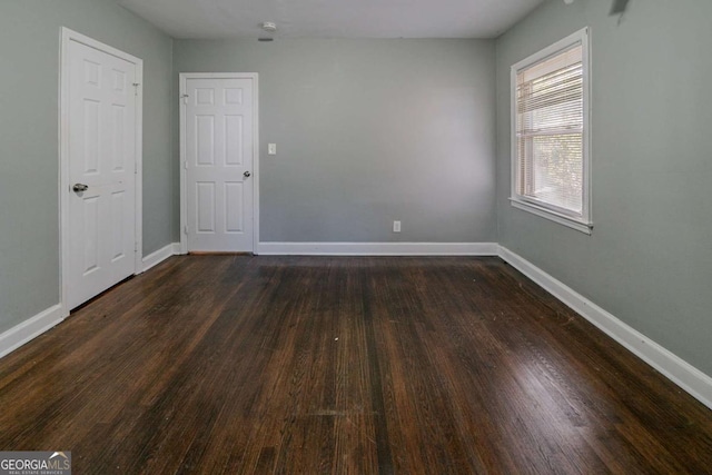 spare room with dark hardwood / wood-style floors