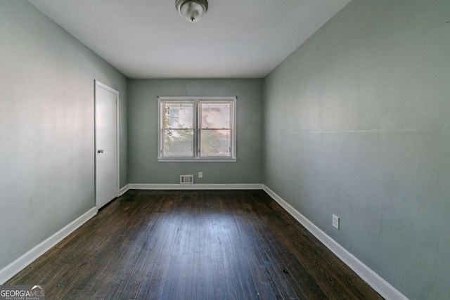 unfurnished room with dark hardwood / wood-style floors