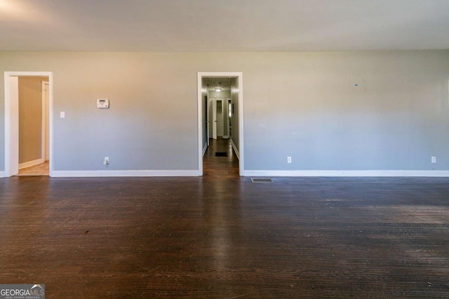 spare room featuring dark hardwood / wood-style flooring