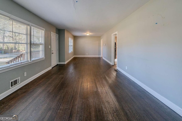 unfurnished room featuring dark wood-type flooring