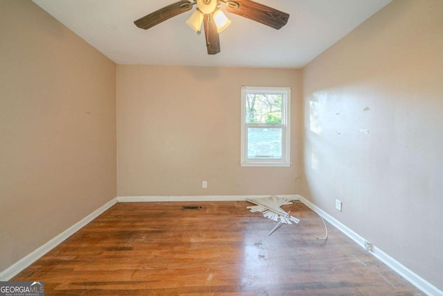 empty room featuring ceiling fan and hardwood / wood-style flooring