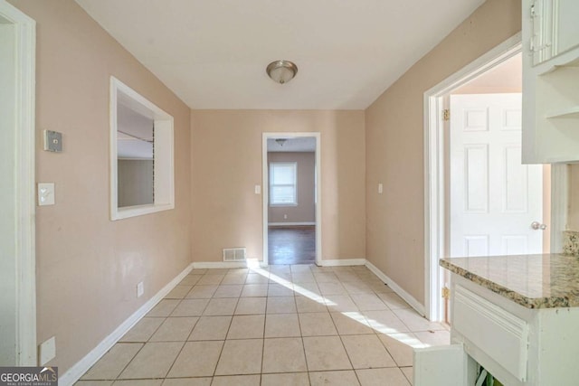 unfurnished dining area featuring light tile patterned floors