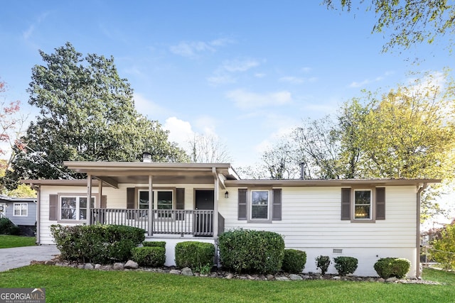 ranch-style home with covered porch and a front lawn