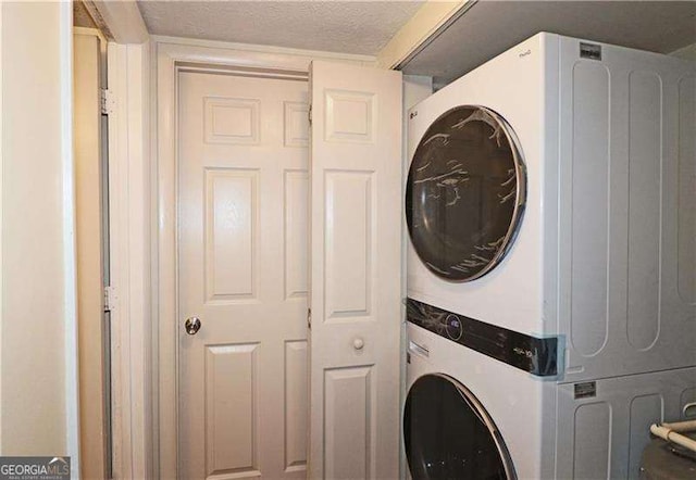 1150 Collier Rd NW Unit 4B, Atlanta, GA 30318 - laundry area with a textured ceiling and stacked washer / dryer