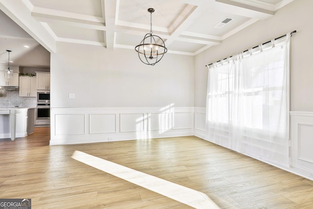 doorway to outside with beam ceiling, french doors, coffered ceiling, an inviting chandelier, and light wood-type flooring