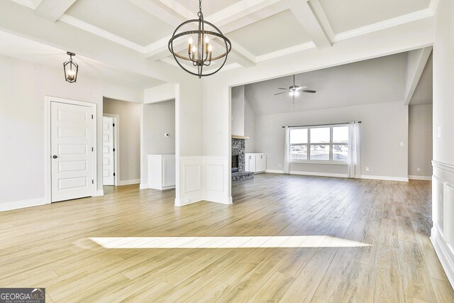 unfurnished dining area featuring a chandelier, beamed ceiling, light hardwood / wood-style floors, and coffered ceiling