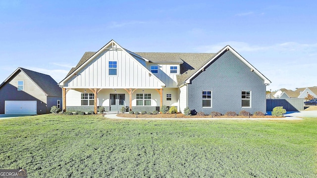 view of front of property featuring a front lawn and board and batten siding