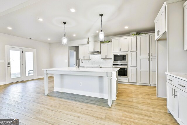 unfurnished dining area with coffered ceiling, an inviting chandelier, beamed ceiling, light hardwood / wood-style floors, and ornamental molding