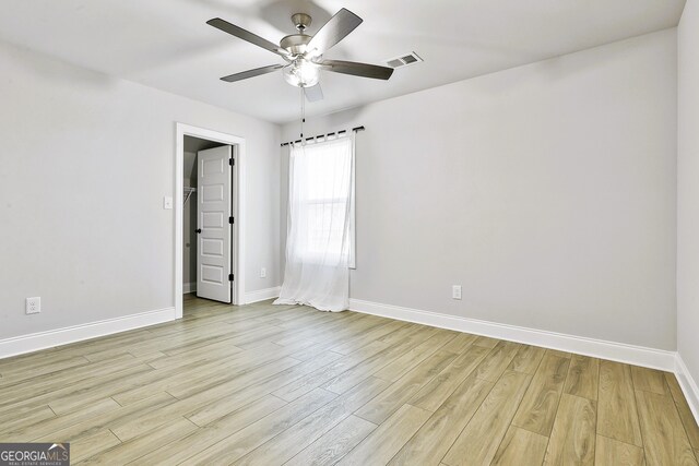 spare room with ceiling fan and light hardwood / wood-style floors