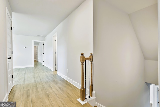 staircase with sink and hardwood / wood-style flooring