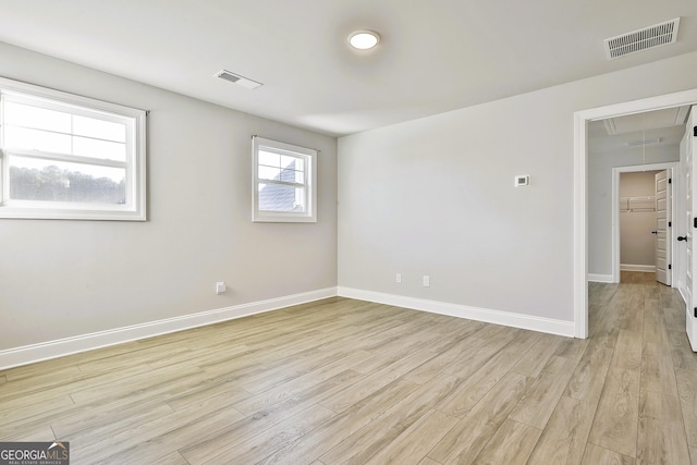 hall with vaulted ceiling and light wood-type flooring