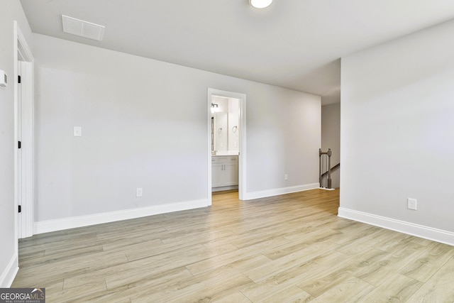 unfurnished room featuring a wealth of natural light and light hardwood / wood-style flooring