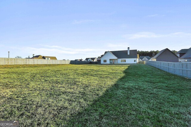 rear view of property with central AC