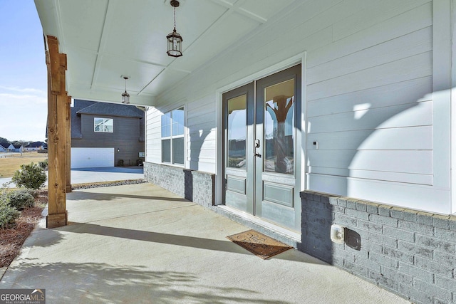 property entrance with a porch and french doors