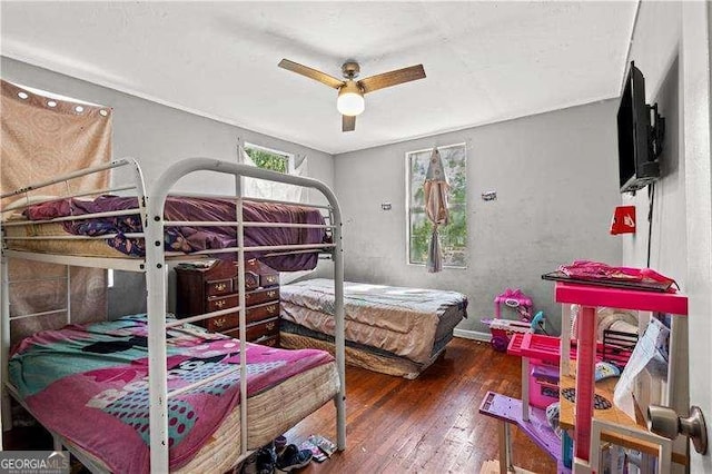 bedroom featuring ceiling fan and dark wood-type flooring