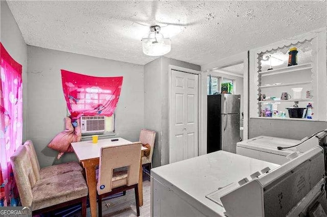 interior space with cooling unit, washer / clothes dryer, a textured ceiling, and stainless steel refrigerator