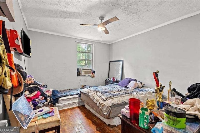 bedroom with a textured ceiling, ceiling fan, and dark hardwood / wood-style floors