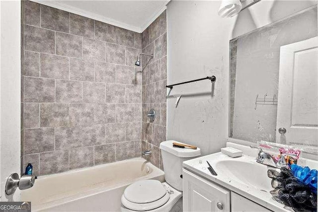 full bathroom featuring vanity, toilet, crown molding, and tiled shower / bath combo