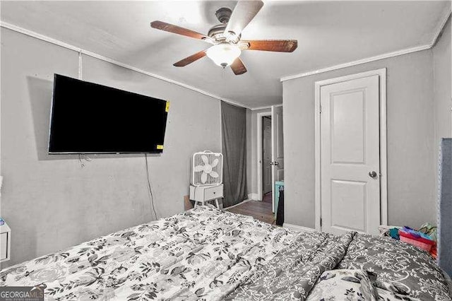 bedroom with ceiling fan and crown molding