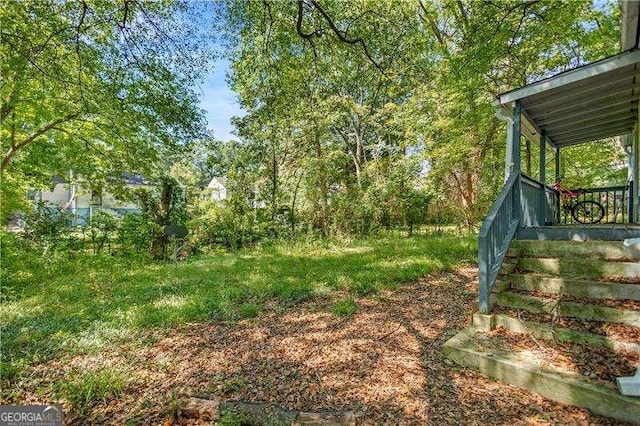 view of yard featuring covered porch