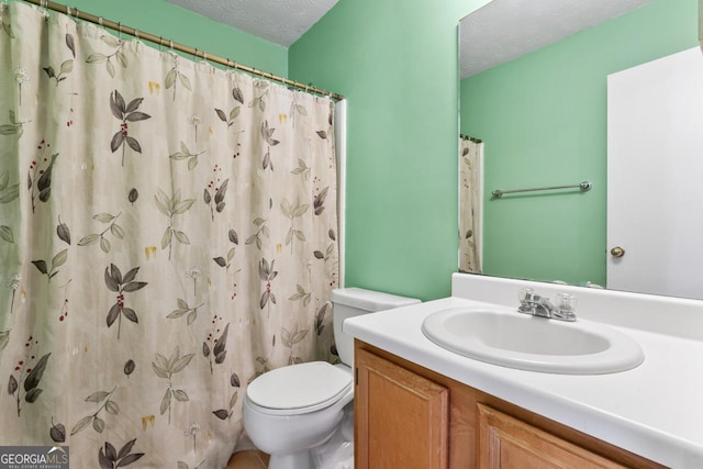 bathroom with walk in shower, vanity, a textured ceiling, and toilet