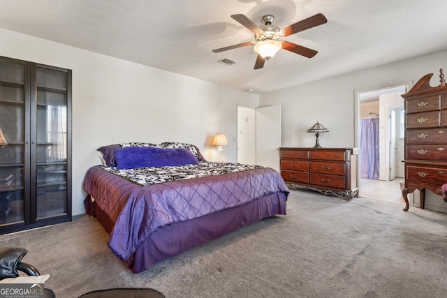 carpeted bedroom featuring a textured ceiling and ceiling fan