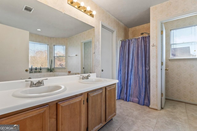 bathroom with tile patterned floors, plenty of natural light, and vanity