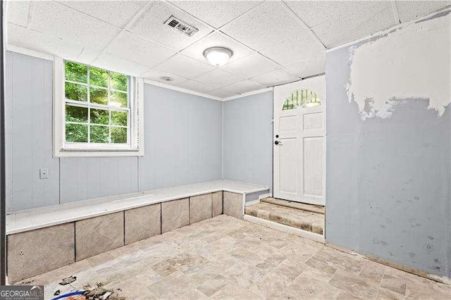 unfurnished room featuring a drop ceiling