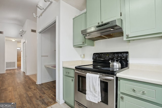 kitchen featuring vaulted ceiling, dark hardwood / wood-style flooring, stainless steel range with electric cooktop, and green cabinetry