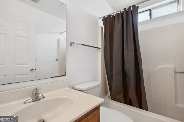 full bathroom featuring vanity, shower / bath combo, and toilet