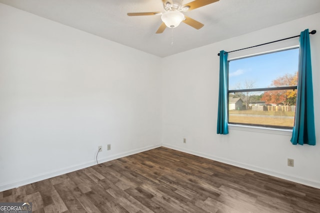 empty room featuring dark hardwood / wood-style flooring and ceiling fan