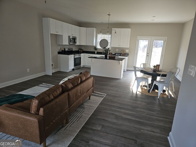 living room with dark hardwood / wood-style floors and french doors