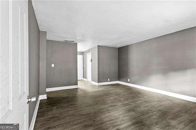 empty room featuring dark hardwood / wood-style floors