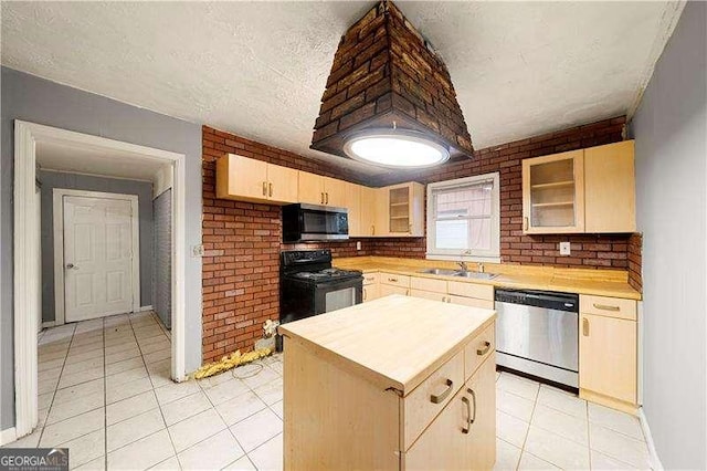 kitchen with light tile patterned flooring, sink, light brown cabinetry, appliances with stainless steel finishes, and a kitchen island