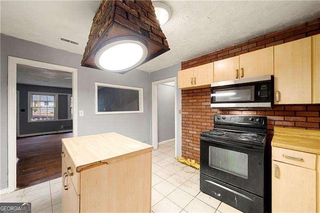 kitchen with butcher block counters, electric range, light brown cabinets, and light tile patterned flooring