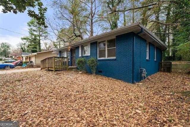 ranch-style house with a wooden deck