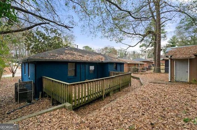 back of house featuring a wooden deck