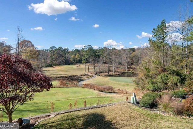 view of property's community featuring a water view and a yard