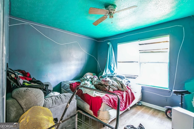 bedroom with hardwood / wood-style floors and ceiling fan