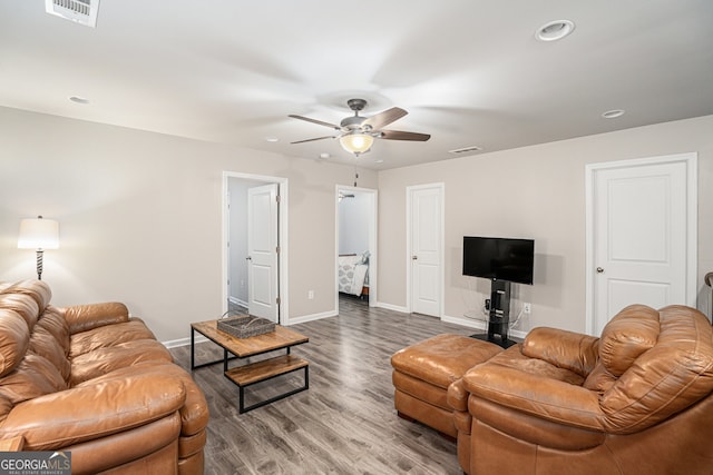 living room featuring wood-type flooring and ceiling fan